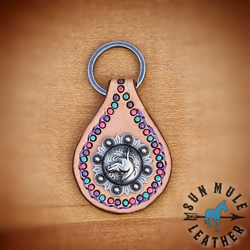 Natural colored handmade leather keychain with a mule concho, on an antiqued flat split key ring. 