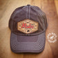 Unstructured mule hat, hat with hand tooled leather patch, featuring the word "Mules". 