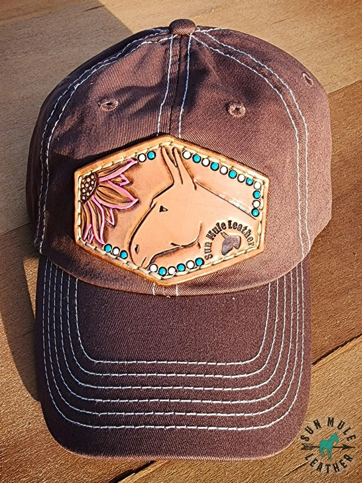 Mule hat with leather hat patch of hand tooled mule and flower. 