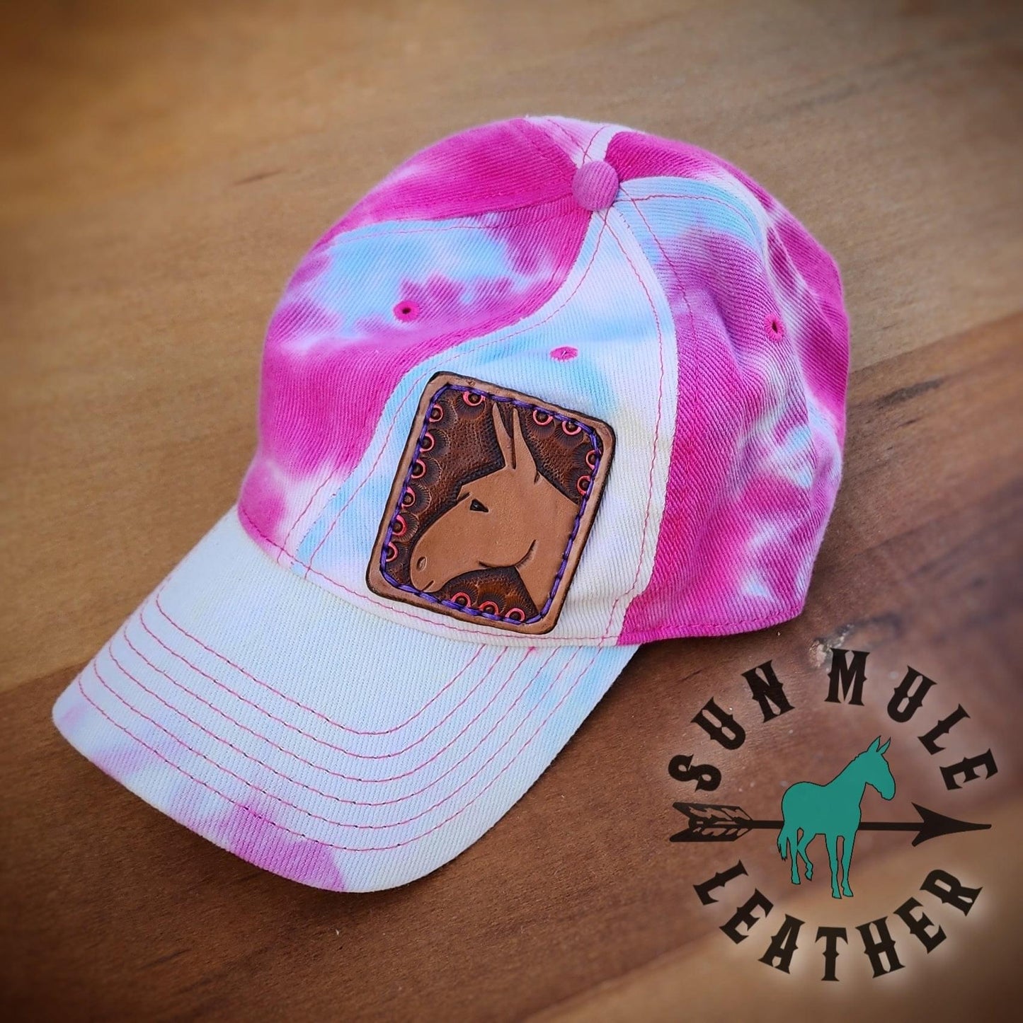 Tie-dyed mule hat with hand tooled leather mule patch.