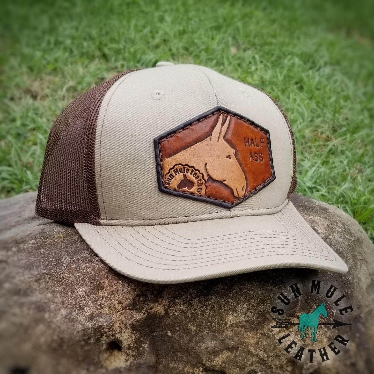 Leather patch mule hat with the words "Half Ass" stamped. Trucker Cap.