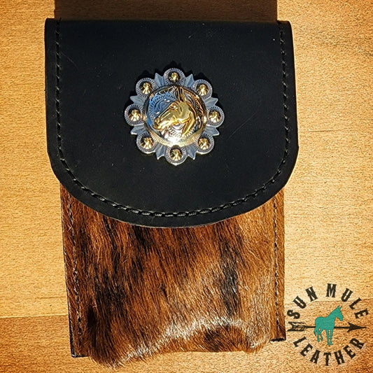 Leather phone holder holster made to wear on belt or attach to saddle, has a 2" mule concho on the top. 